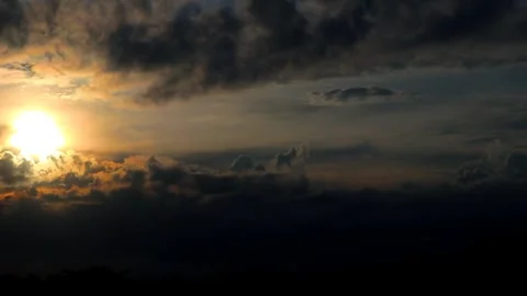 The sun is setting behind the clouds. Stock Footage 296823739