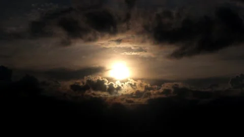 The sun is setting behind the clouds. Stock Footage 296824125