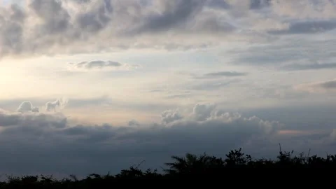 The sun is setting behind the clouds. Stock Footage 296824161