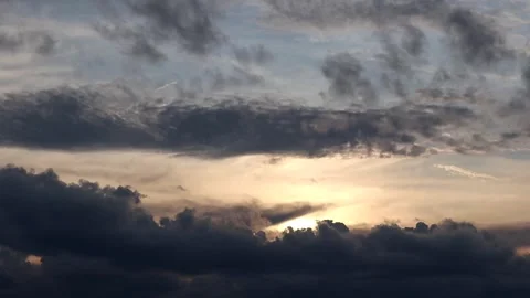 The sun is setting behind the clouds. Stock Footage 296824211
