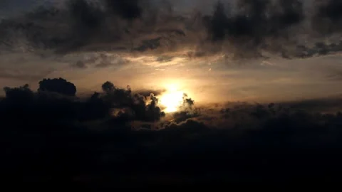 The sun is setting behind the clouds. Stock Footage 296824228
