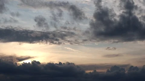 The sun is setting behind the clouds. Stock Footage 296824245
