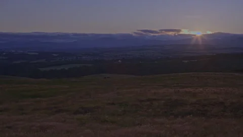 Sun setting behind clouds over the countryside near Dunblane, Scotland Stock Footage 340661859