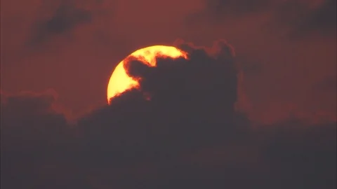 Sun setting behind the dark clouds Stock Footage 88888535