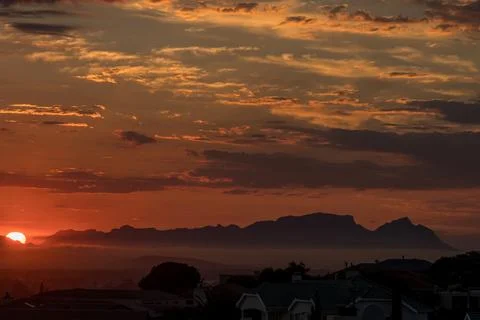 Sun is setting behind Fish Hoek accross False Bay 库存照片