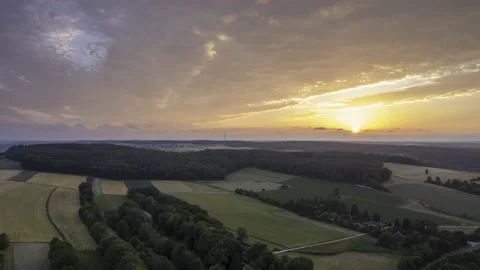 Sun is setting behind forests of Swabian Jura with colorful clouds time lapse Stock Footage 200569271