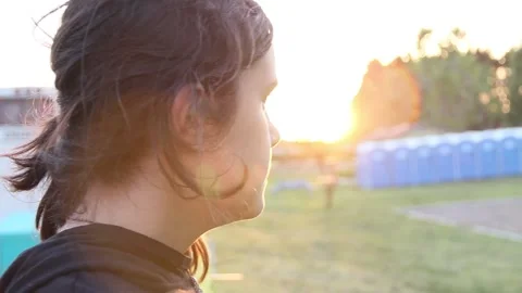 Sun setting behind girl Stock Footage 154992218