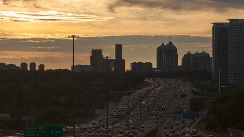 Sun setting behind Highway 401, Toronto, Canada. (Day to Night- time-lapse) Stock Footage 129906712