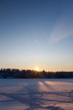 A sun setting behind a hill Stock Photos
