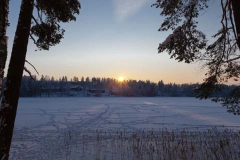A sun setting behind a hill Stock Photos