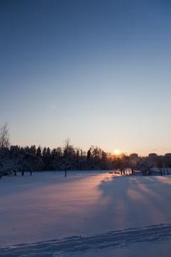 A sun setting behind a hill Stock Photos