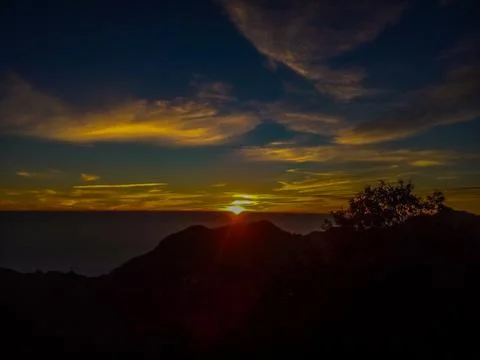 Sun setting behind the hill Stock Photos