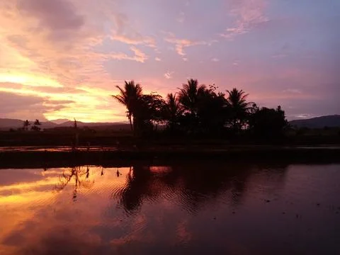 The sun is setting behind the house Stock Photos