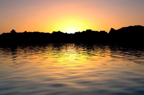 Sun Setting Behind an Island, Creating a Silhouette Stock Photos