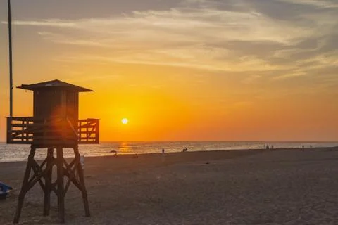 Sun Setting Behind Lifeguard Tower Photos