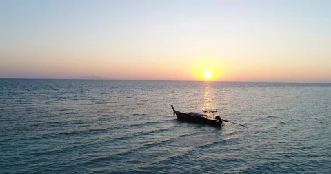 Sun setting behind a Long Tail Boat, Koh Phangan, Thailand Stock Footage 98931118