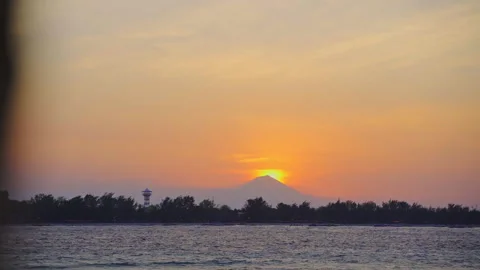 Sun Setting Behind Misty Mountain Over Island Stock Footage 146105108