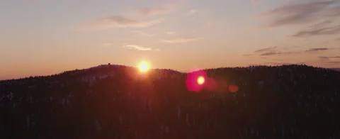 Sun setting behind a mountain Stock Footage 140103275