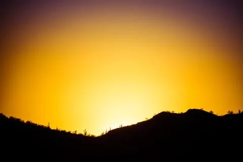 The Sun Setting Behind a Mountain Photos