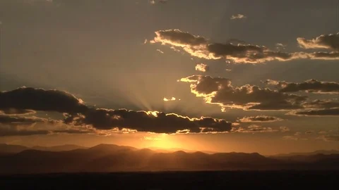 Sun setting behind mountains Stock Footage 74096251