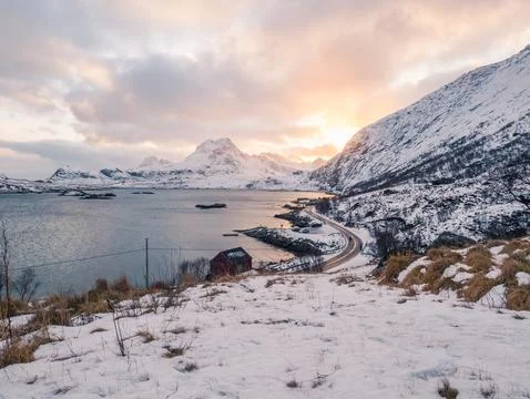 Sun setting behind mountains in Lofoten fjord Foto stock