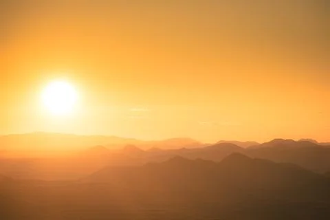 The sun setting behind the mountains of the Sonoran Desert in Arizona with th Photos