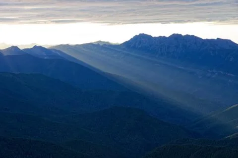 Sun setting behind the Olympic Mountains Stock Photos