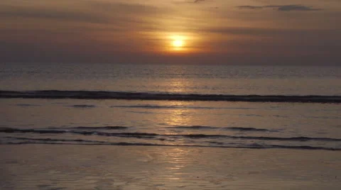 The sun is setting behind the perfect fine golden sandy beach Stock Footage 60417864
