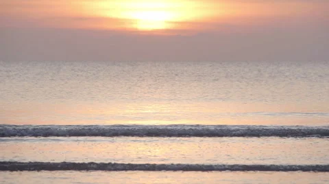 The sun is setting behind the perfect fine golden sandy beach Stock Footage 60419988