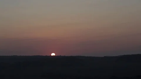 Sun setting behind Rocky Desert Horizon Stock Footage 72583296