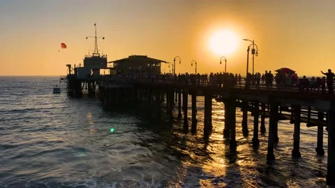 The sun setting behind Santa Monica Pier, 4K Stock Footage 220305898