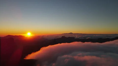 Sun setting behind a sea of clouds with Teide volcano in the background Stock Footage 313290377