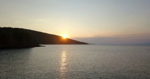 Sun setting behind the sea coastline Stock Footage 108724248