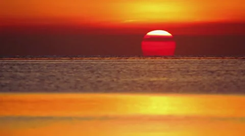 The sun setting behind the sea Stock Footage 63604760