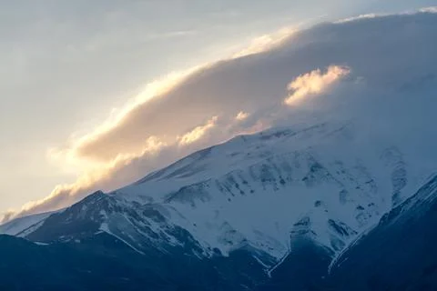 Sun setting behind the slope of Mt. Damavand, the highest stratovolcano in Asia Stock Photos