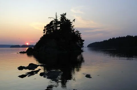 Sun setting behind a small islet, Wallace Island, Gulf Islands, British Colum Stock Photos