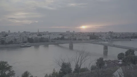 Sun setting behind Varadinski Bridge and Novi Sad, Serbia, pan right-Slog2 Stock Footage 93260025