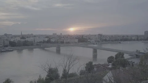 Sun setting behind Varadinski Bridge and Novi Sad, Serbia, pan left-Slog2 Stock Footage 93260061