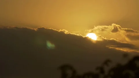 Sun setting behind a wall of clouds in the yellow sky Stock Footage 77803486