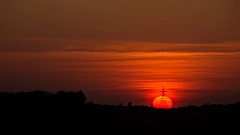 Sun setting behing a powerline, timelapse 스톡 동영상 78020307