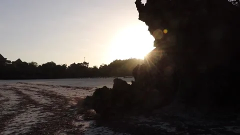 Sun setting beside rocks Stock Footage 170194156