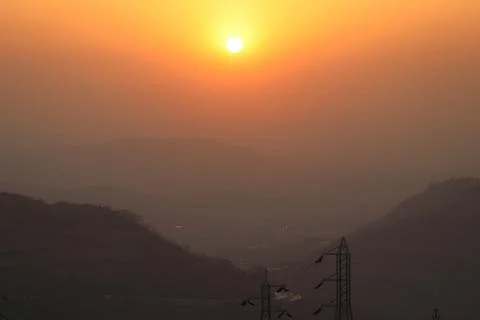 The sun is setting between the mountains Foto stock