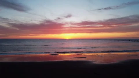 Sun setting beyond horizon in distance Stock Footage 260370071