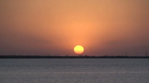 Sun setting beyond a lake  s3 Stock Footage 26350728