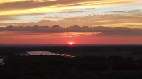 Sun setting with bright orange pink and yellow colors Stock Footage 155519690