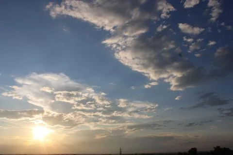 Sun setting with clouds in the foreground Stock Photos