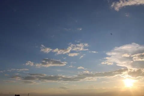 Sun setting with clouds in the foreground Stock Photos