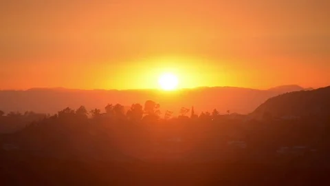 Sun setting completely over horizon countryside los angeles griffith Stock Footage 83559675