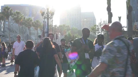 Sun setting at convention center, glare, lens flair, crowds walk at end of day Stockbeeldmateriaal 246636018