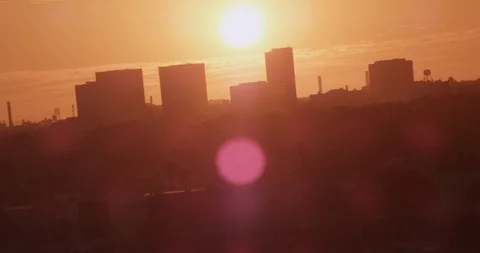Sun setting creating yellow haze over city skyline, aerial shot Video stock 104688269